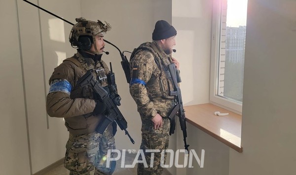 우크라이나인으로 보이는 팀원과 작전중인 이근 대위. 팀원은 무전기의 형태로 보아 팀 무전병으로 보인다.